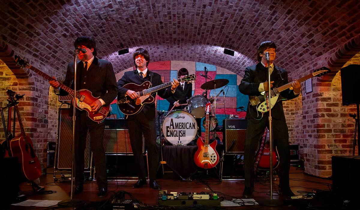 American English Beatles tribute band performing live on stage at Let It Be music venue in Waukesha, Wisconsin.