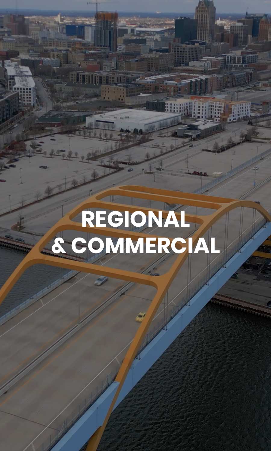 Drone View of Hoan Bridge and Milwaukee Lakefront Skyline Aerial drone view of Milwaukee’s Hoan Bridge with downtown city buildings and Lake Michigan in the background.