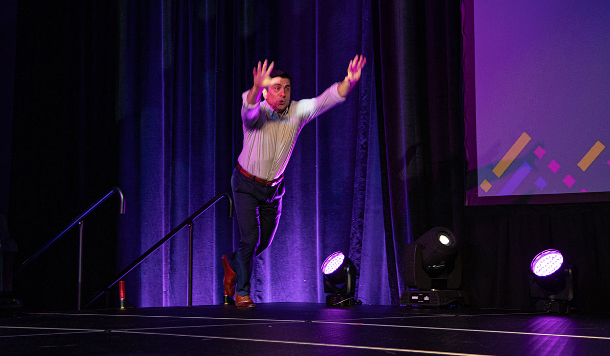 Keynote Sprint Sequence at Converge Summit – Baird Center Keynote speaker sprinting on stage with energetic motion blur captured in rapid shutter sequence at Converge Technology Summit in Milwaukee