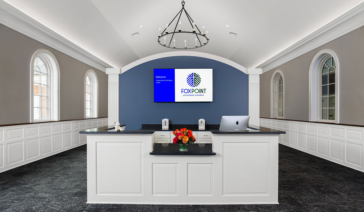Welcome Desk at Fox Point Lutheran Church Front desk and welcome area at Fox Point Lutheran Church with modern wood finishes and welcoming design