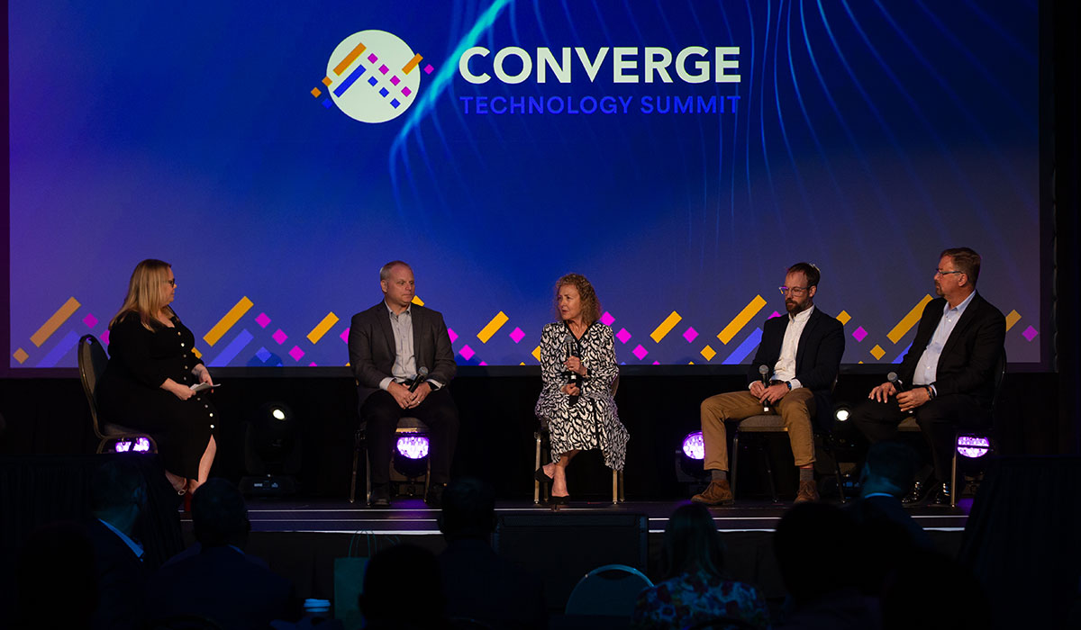 Tech Leaders Panel – IBM, HP, and Fortune 1000 at Converge Summit Industry experts from IBM, HP, and Fortune 1000 companies seated on stage during a panel at the Converge Technology Summit in Milwaukee