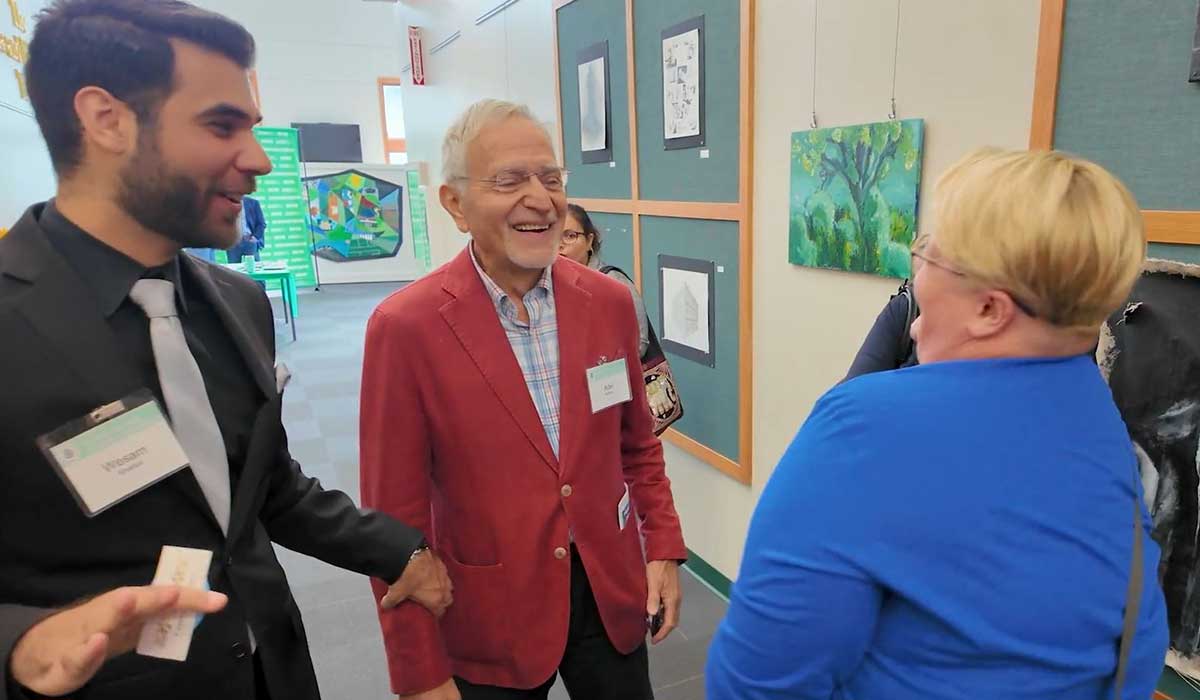 Candid moment of shared laughter between the AB Korkor Foundation leader and the event MC during the 2024 Motion Impacts Emotion Conference.